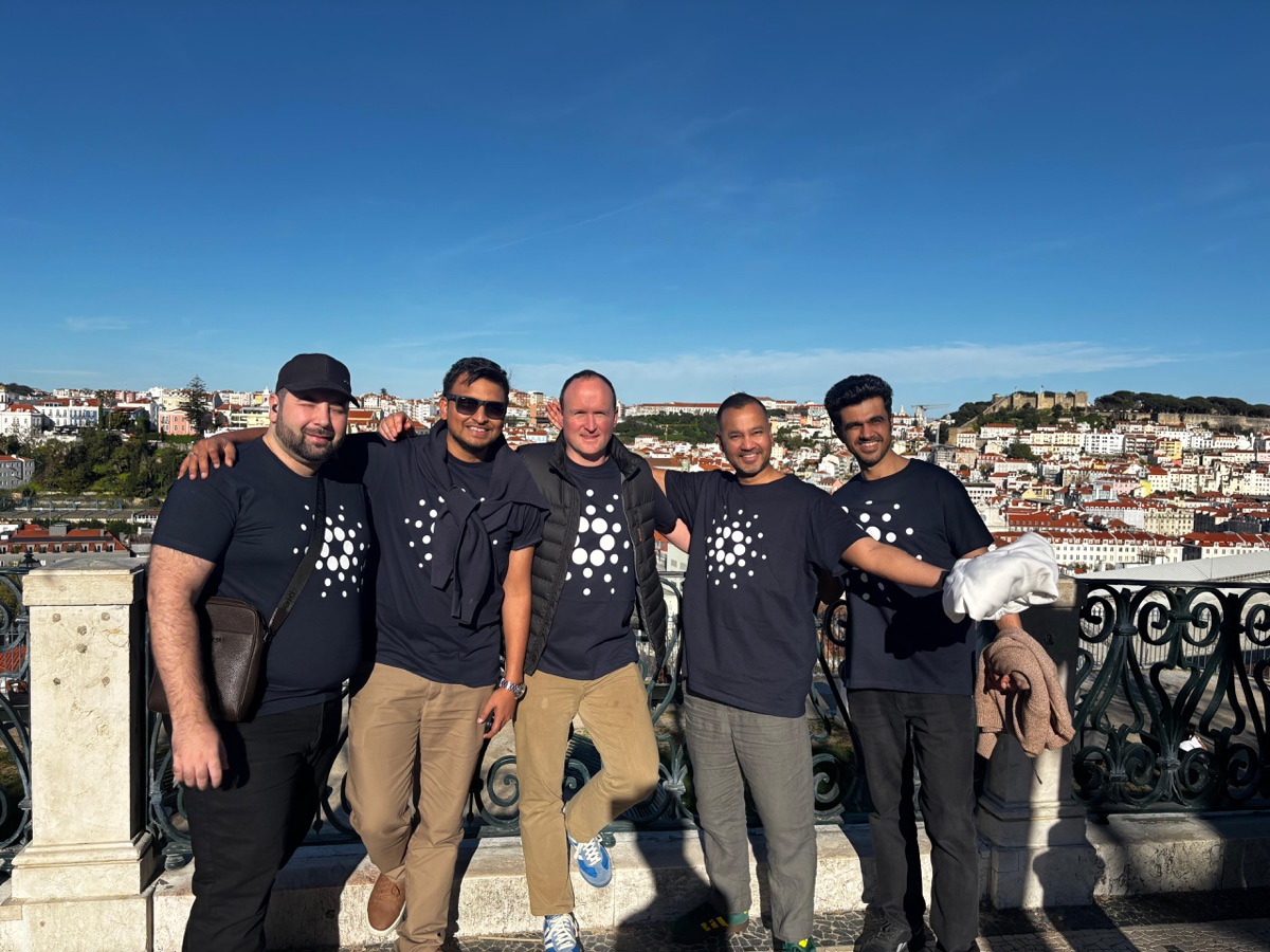 Spring '26 cohort group photo in Cardano t-shirts overlooking Lisbon